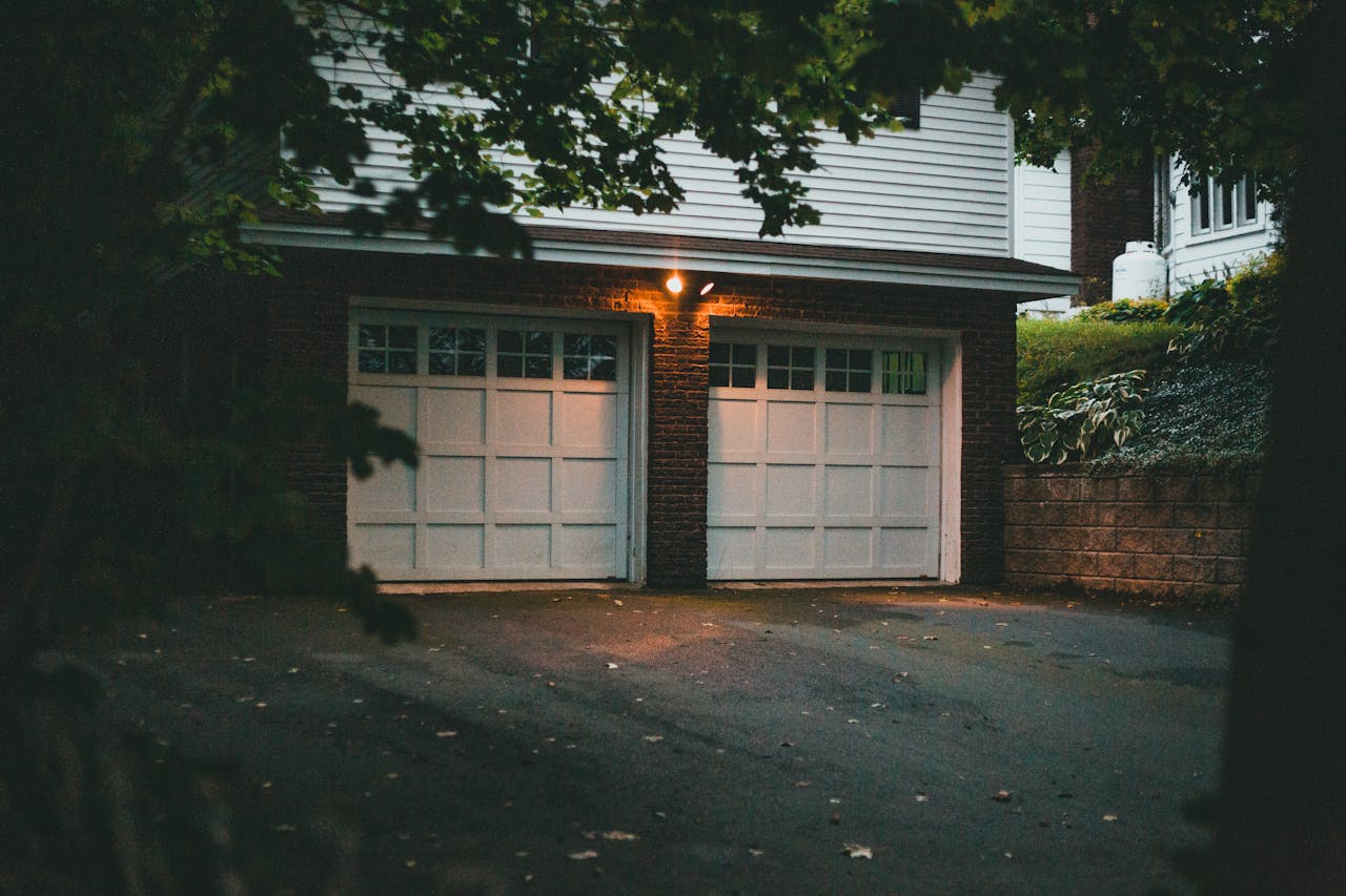 services-01 Warm evening view of a suburban garage with soft lighting creating a cozy atmosphere.